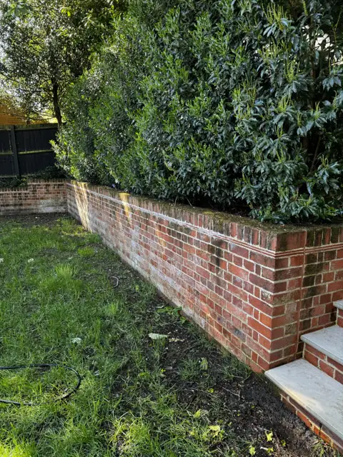 Brick retaining wall clean in Harpenden, before cleaning by Renaco